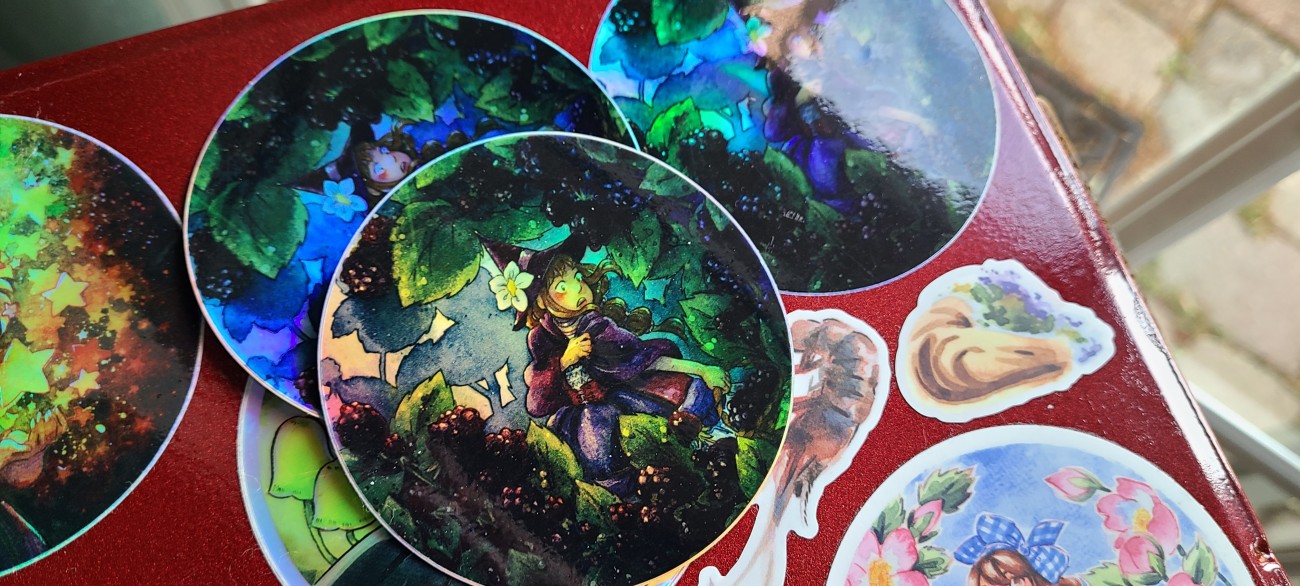 A cute little witch running through the berries- now as a holographic sticker!