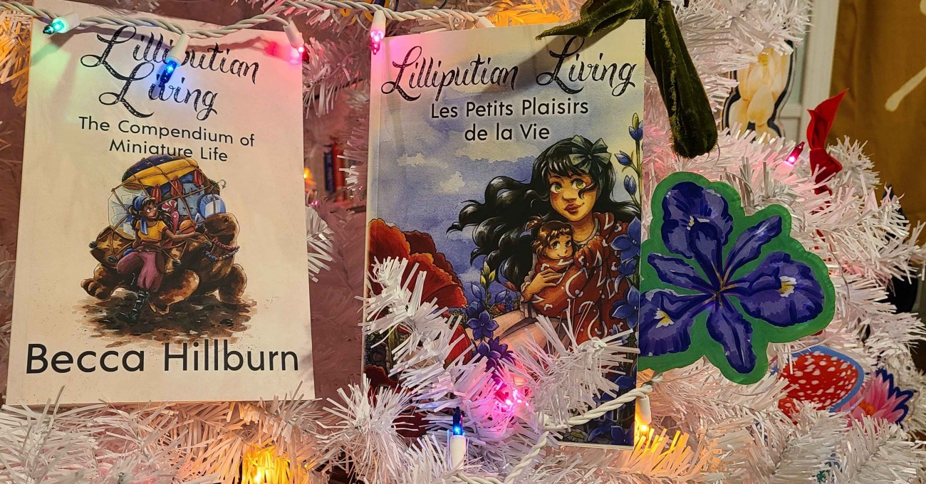 Both Lilliputian Living books in a white Christmas tree