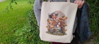 A natural cotton tote bag featuring a Renn Faire or fantasy inspired girl running through oversized mushrooms.  She wears a kerchief and a plaid skirt, and her hair is floating behind her.