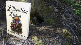 Lilliputian Living Compendium book in the woods.